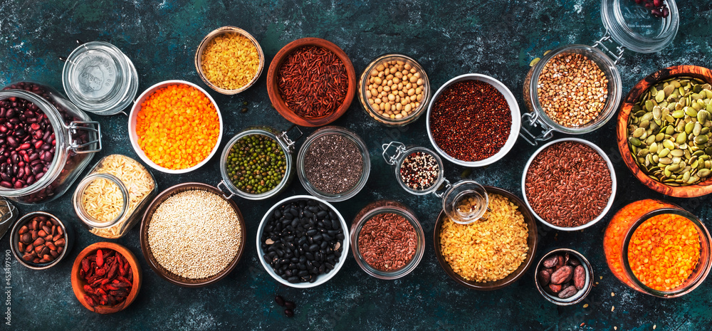 Set of superfoods, legumes, cereals, nuts, seeds in bowls on blue table. Copy space, top view Set of superfoods, legumes, cereals, nuts, seeds in bowls on blue table. Copy space, top view