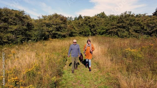 A mature couple talking a walk in the country on a lovely autumn day.