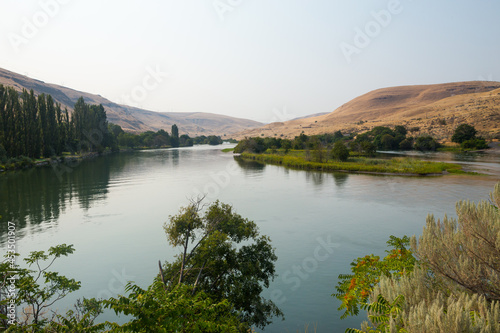 Deschutes River in Oregon. Plants reflect in a calm water