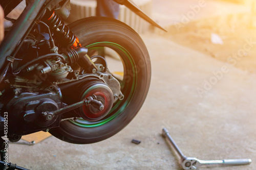 Blurred image,motorcycles repair after a tire leak during a long journey. Modifying some parts of a car when it is used for a certain period of time by an expert technician. motorcycles repair © thatinchan