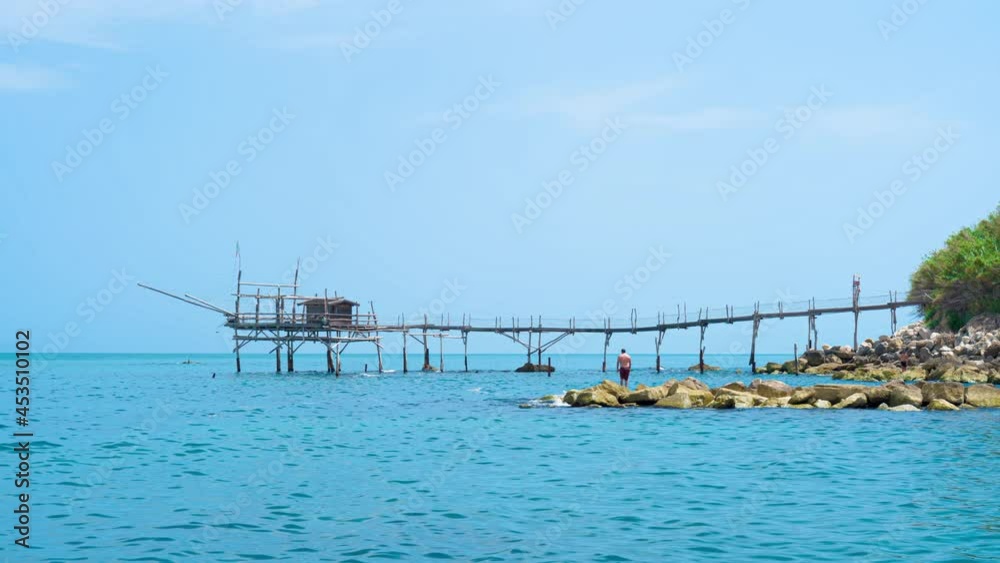 Trabocco Turchino in San Vito Chietino, Abruzzo. Trabucco a sort of Trebuchet, traditional fishing house on Costa dei Trabocchi (Coast Of the Trabocchi) Unesco heritage 4K CINEMATIC CAMERA RAW FOOTAGE Trabocco Turchino in San Vito Chietino, Abruzzo. Trabucco a sort of Trebuchet, traditional fishing house on Costa dei Trabocchi (Coast Of the Trabocchi) Unesco heritage 4K CINEMATIC CAMERA RAW FOOTAGE