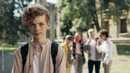 Cruel kids bullying unpopular classmate, teen boy suffering socializing problem