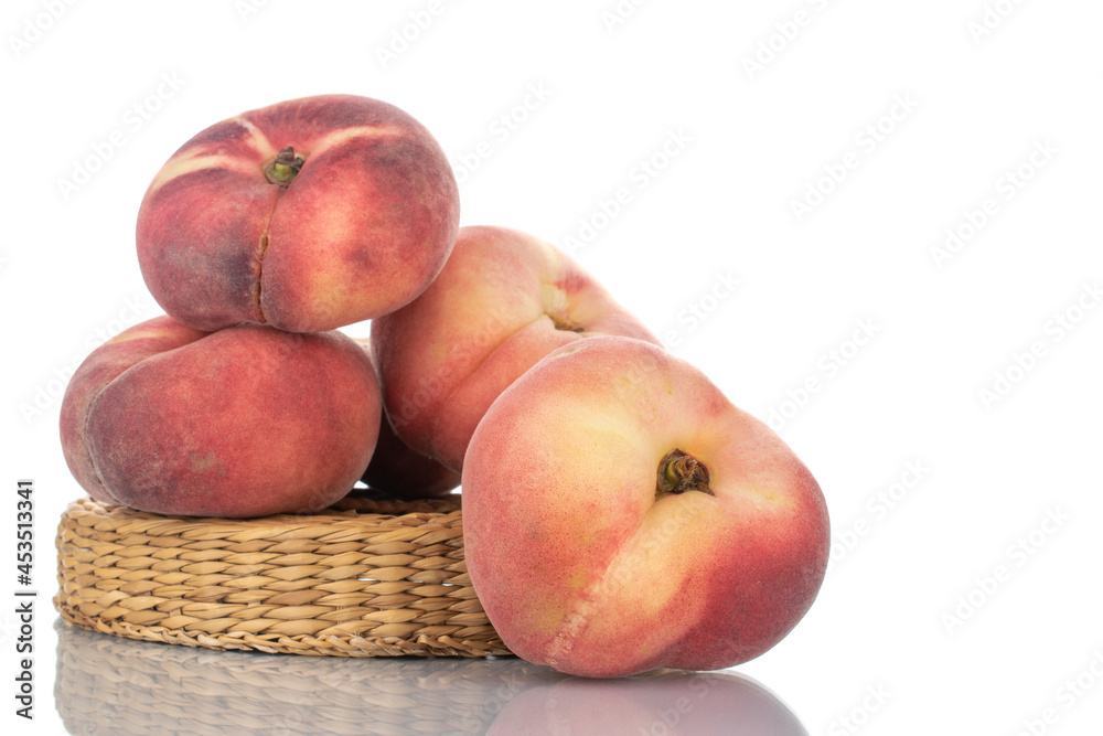 Several juicy organic peaches with a straw stand, close-up, isolated on white. Several juicy organic peaches with a straw stand, close-up, isolated on white.