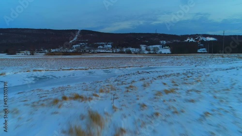 Snow Covered Wheat Field  - Low-Level Pull Back Flight photo