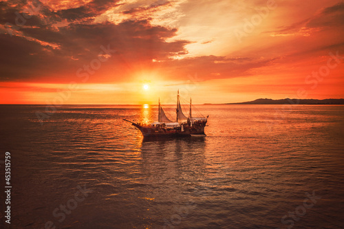 Fototapeta Naklejka Na Ścianę i Meble -  Pirate boat with a beautiful sunset as the background, the boat name is Marigalante and Iconic ship at Puerto Vallarta