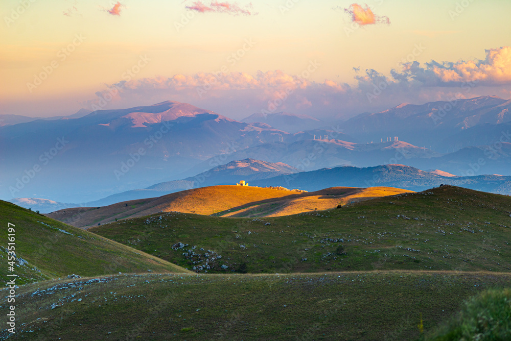 Castle ruins and small chapel at Rocca Calascio italian travel destination, landmark in the Gran Sasso National Park, Abruzzo, Italy. Sunset view Castle ruins and small chapel at Rocca Calascio italian travel destination, landmark in the Gran Sasso National Park, Abruzzo, Italy. Sunset view