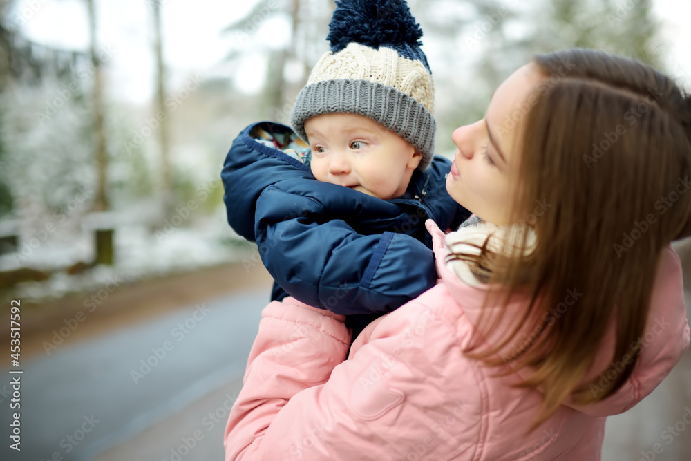 Big sister and her baby brother having fun outdoors. Young girl holding her baby  boy sibling on winter day. Kids with large age gap Stock Photo | Adobe Stock
