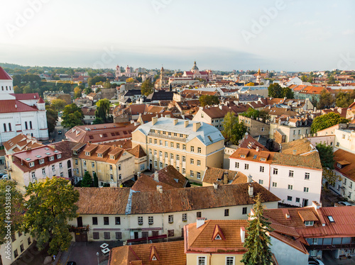 Beautiful Vilnius city panorama in autumn with orange and yellow foliage. Aerial evening view.