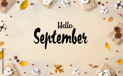 Hello September message with gift boxes with leaves