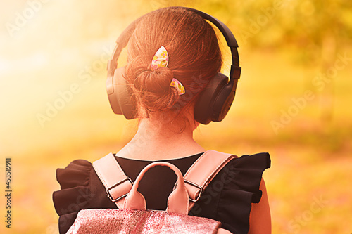 Girl wearing headphones. Stereo sound. Headphones with wireless technology.