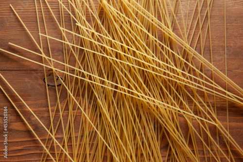 Yellow Spaghetti scattered on the table. Italian food concept. Spaghetti artistic background. High quality photo