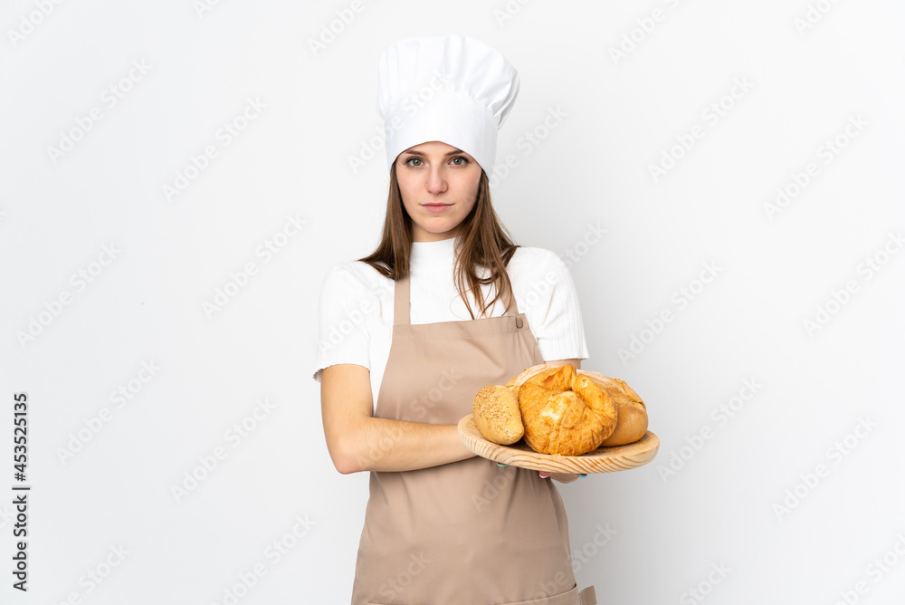 Young woman in chef uniform isolated on white background keeping arms crossed Young woman in chef uniform isolated on white background keeping arms crossed