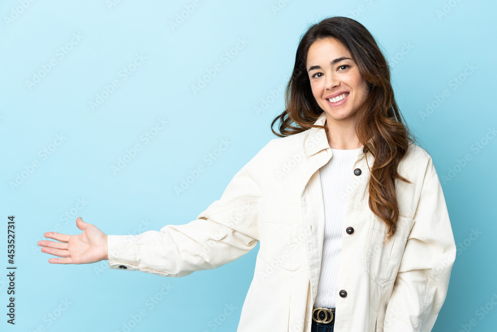 Woman over isolated background extending hands to the side for inviting to come Woman over isolated background extending hands to the side for inviting to come