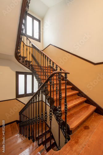 wooden staircase and wrought iron railing in a vintage building in central Madrid