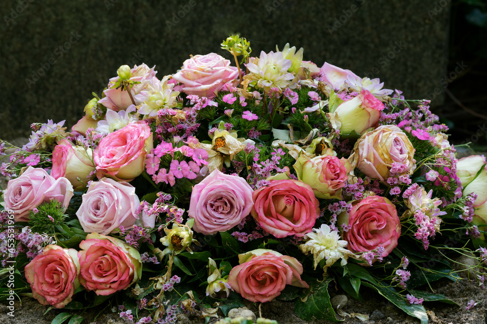 colorful pastel flowers on a grave after a funeral