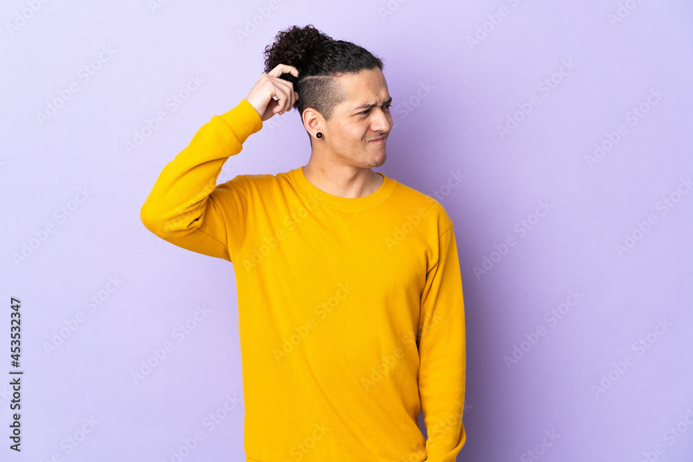Caucasian man over isolated background having doubts while scratching head Caucasian man over isolated background having doubts while scratching head