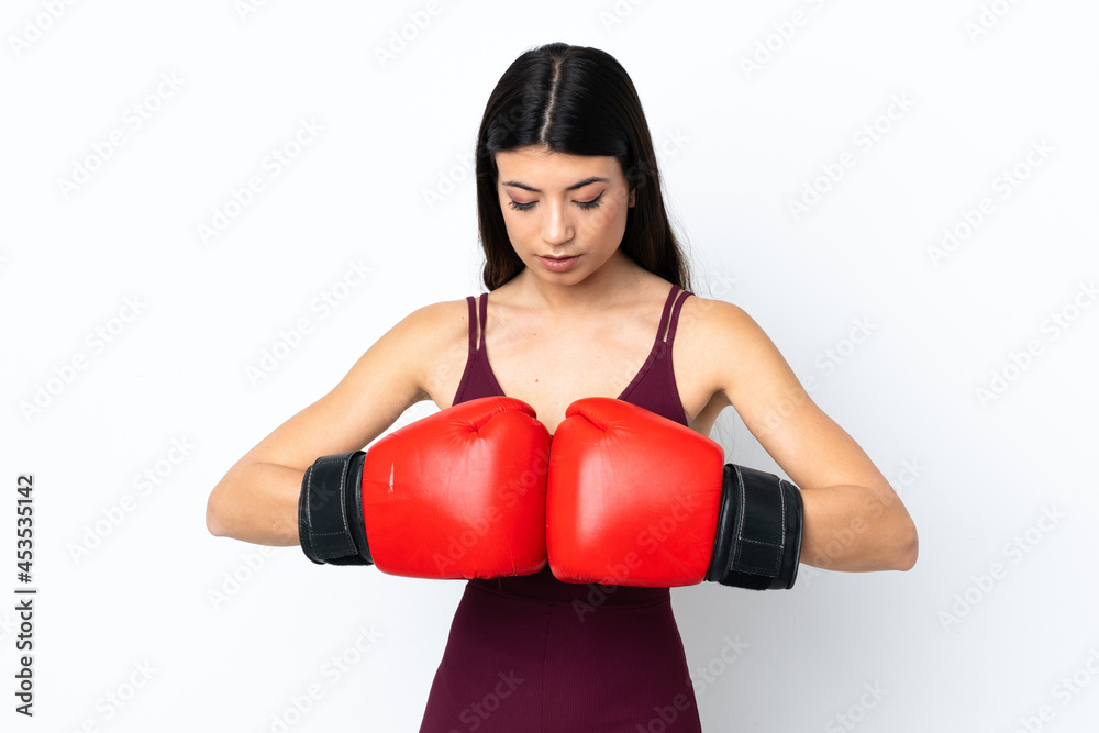 Young sport woman over isolated white background with boxing gloves Young sport woman over isolated white background with boxing gloves