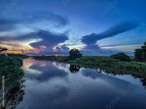 Swamp sunset and hurricane clouds photo