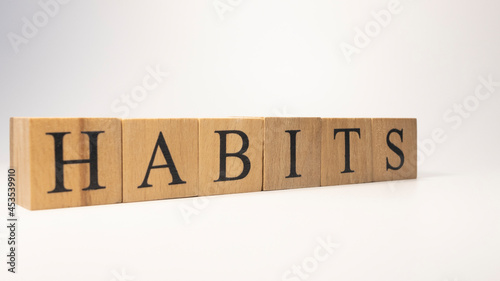 The word HABITS was created from wooden cubes. work and success concept.