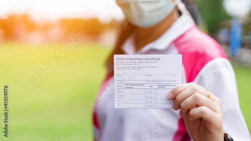Covid-19 vaccination record card concept about standard health care. photo