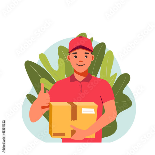 Young male courier in a red uniform with a box in his hands. Courier with a box in his hands shows a thumbs up. Home delivery of goods. Male messenger on a background of leaves
