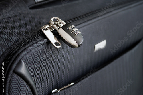Closed combination lock on suitcase. Closeup of padlock locked on case, Safe travel concept.