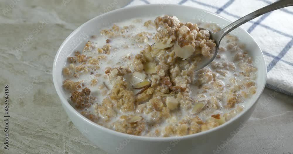Eating a spoonful of almond granola, slow motion Eating a spoonful of almond granola, slow motion