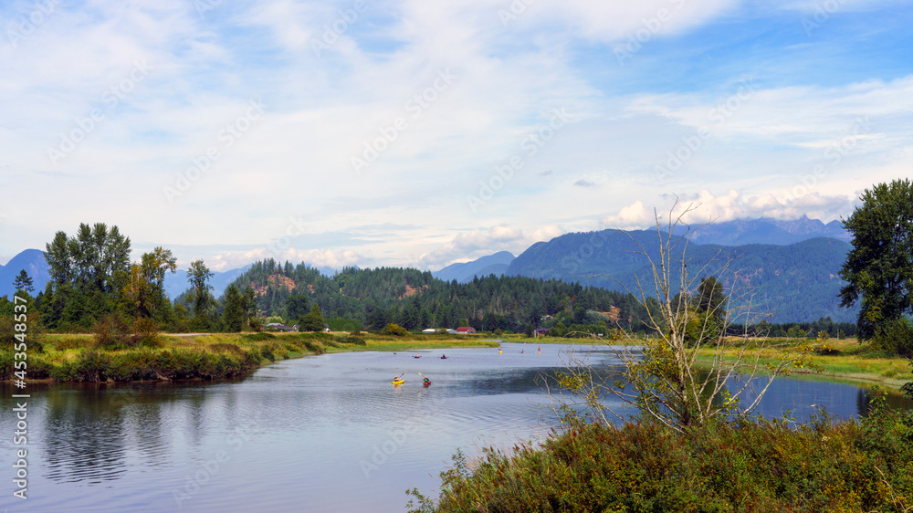 Kayakers and paddleboarders enjoying a peaceful outing surrounded by spectacular scenery and mountains