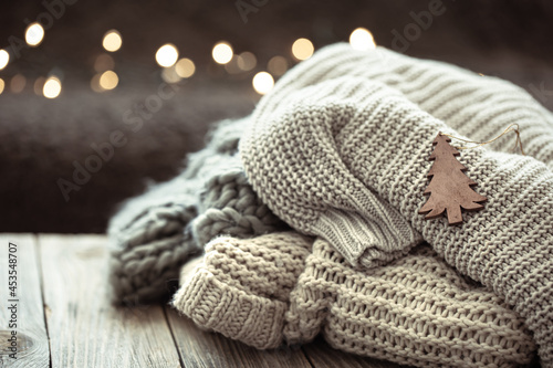 Winter festive background with knitted element on blurred background.