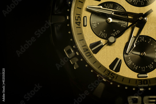Macro photo. Time. The dial of a modern wristwatch. The arrows show the time. Selective focus.