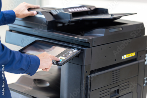 Businessman press button on panel of printer photocopier network , Working on photocopies in the office concept , printer is office worker tool equipment for scanning and copy paper.
