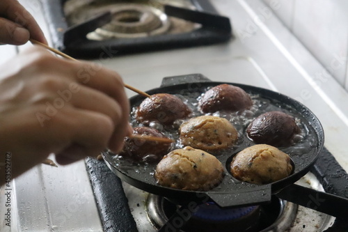 Making of unni appam using unni appam pan. Unni appam or Rice fritters is a traditional snack from the state of Kerala photo