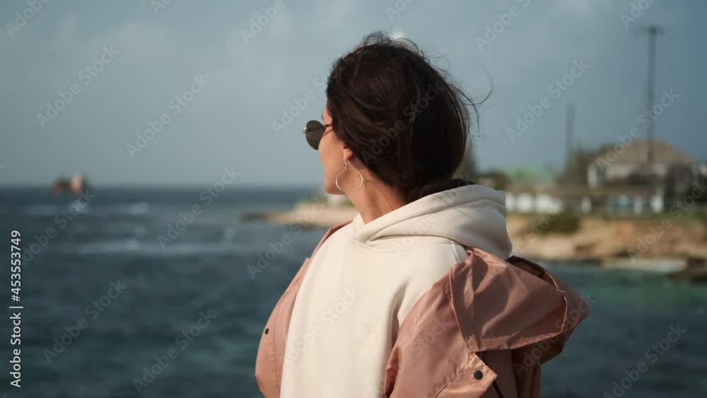 woman is travelling and exploring natural landmark, admiring sea from shore woman is travelling and exploring natural landmark, admiring sea from shore