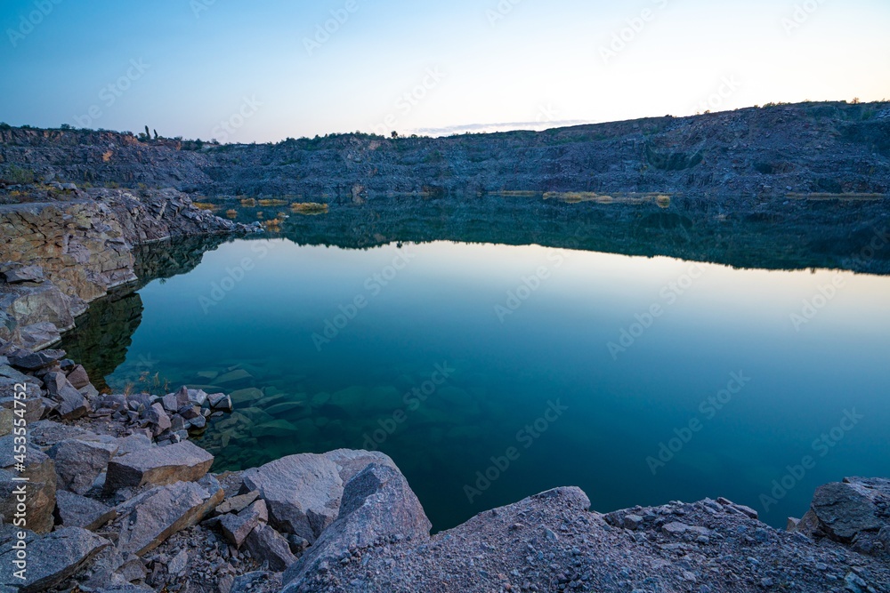 Small lake surrounded by stone waste from mine work