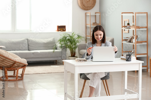 Young woman with laptop at ...