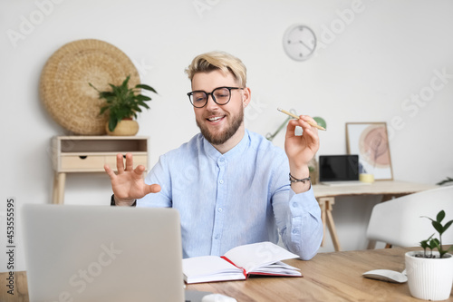 Young man with laptop video...