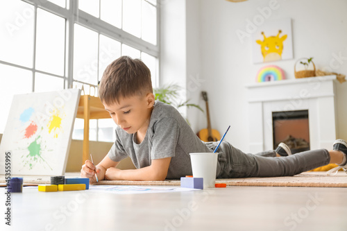 Little boy painting at home