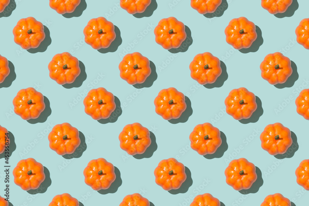 Top view photo of orange pumpkins on isolated light blue background
