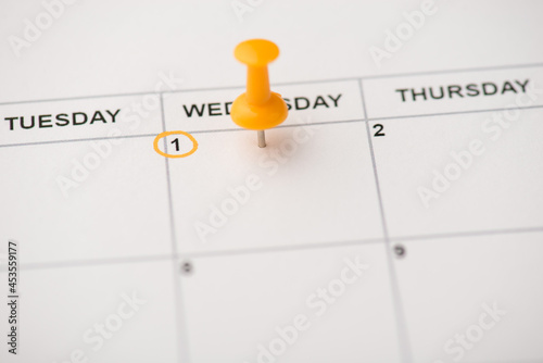 Closeup photo of mark on calendar at wednesday the first with yellow pushpin with empty space
