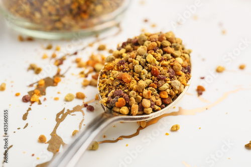 Spoon with bee pollen on white background, closeup