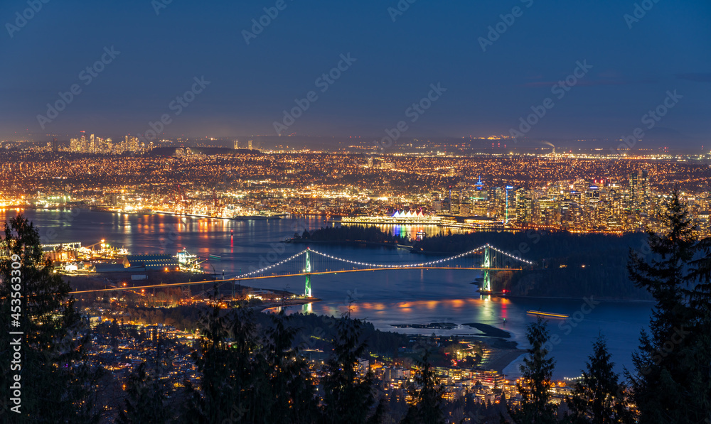 Vancouver city downtown panorama in night. Vancouver Harbour marina aerial view. Lions Gate Bridge, British Columbia, Canada.