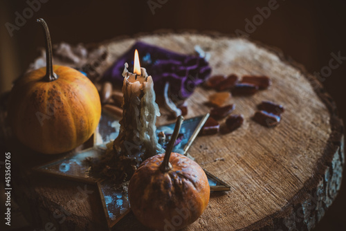 Candle burns on the altar, magic among candles, clean energy, magical concept, autumn time	 photo