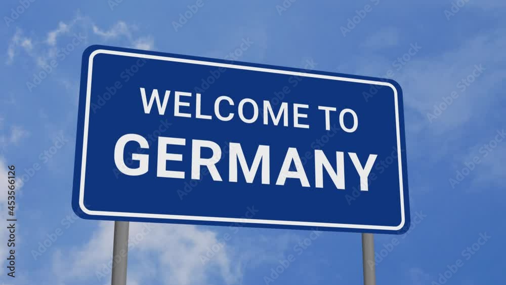 Welcome to Germany Road Sign on Clear Blue Sky with Rapid Moving Clouds Welcome to Germany Road Sign on Clear Blue Sky with Rapid Moving Clouds