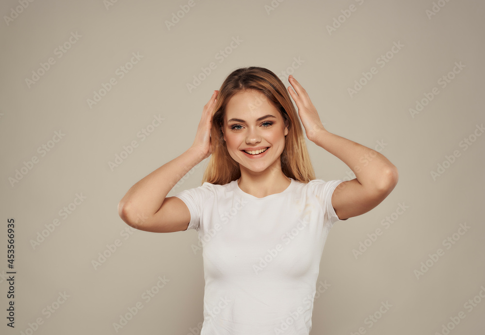 beautiful blonde in a white t-shirt hand gesture Studio Model beautiful blonde in a white t-shirt hand gesture Studio Model
