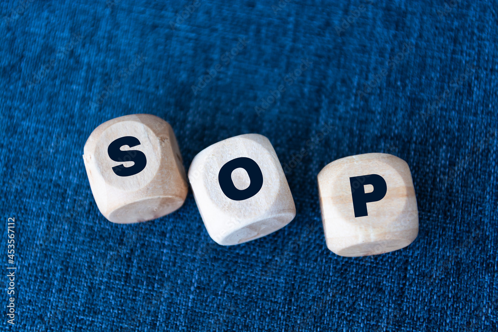 SOP - acronym from wooden blocks with letters, abbreviation SOP ...
