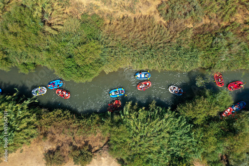 Schilderij op canvas Rubber boats at the Jordan River, heading downstream - Aerial view