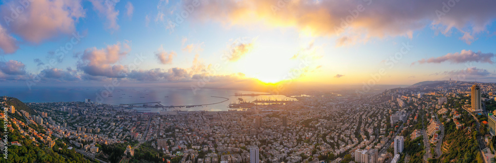 Haifa, Aerial panorama at sunrise, showing the city bay houses and commercial Port.