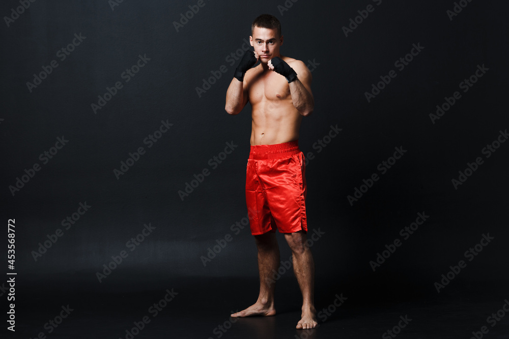 Sportsman muay thai man boxer stance at black background. Sportsman muay thai man boxer stance at black background.