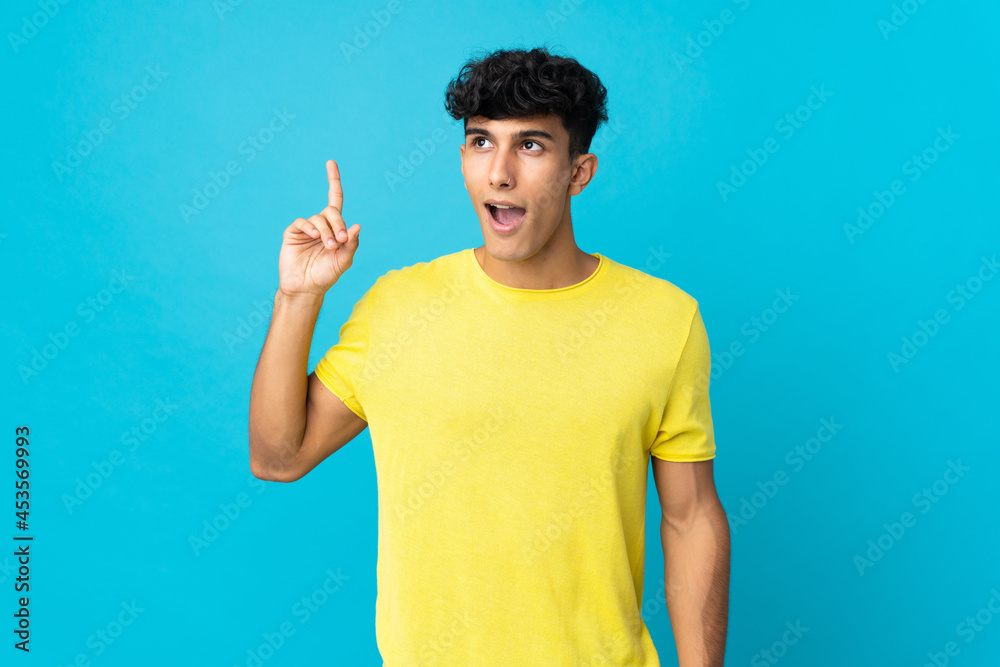 Young Argentinian man isolated on background intending to realizes the solution while lifting a finger up Young Argentinian man isolated on background intending to realizes the solution while lifting a finger up