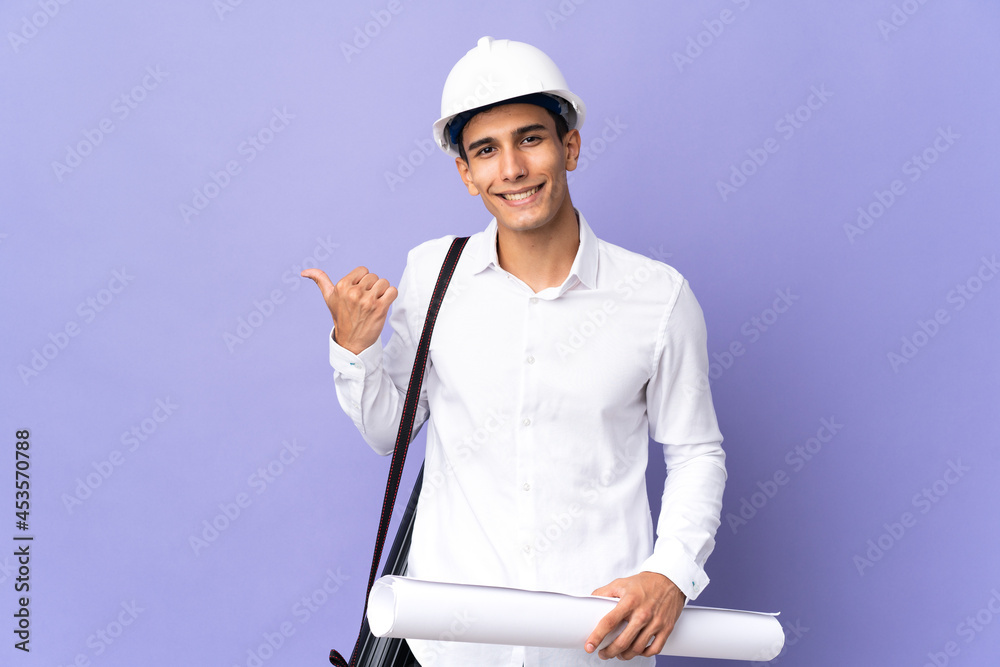 Young architect man isolated on background pointing to the side to present a product Young architect man isolated on background pointing to the side to present a product